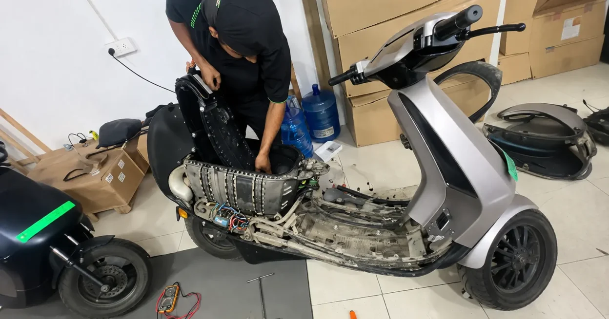 Ola electric scooter battery pack removed for diagnostic inspection at a service centre