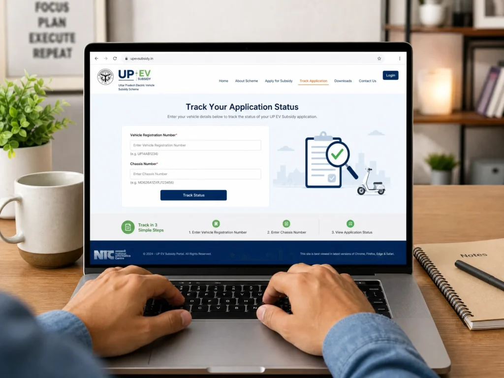A person using a laptop to track UP EV subsidy status on the official upevsubsidy.in portal by entering vehicle registration and chassis numbers.